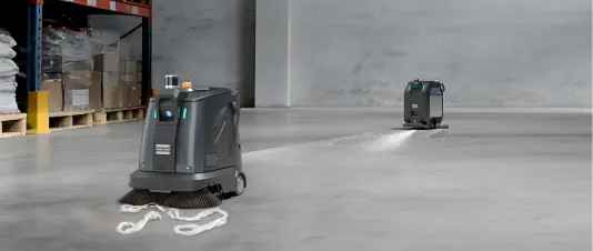 Several S5 sweepers dividing one warehouse floor as a coordinated fleet